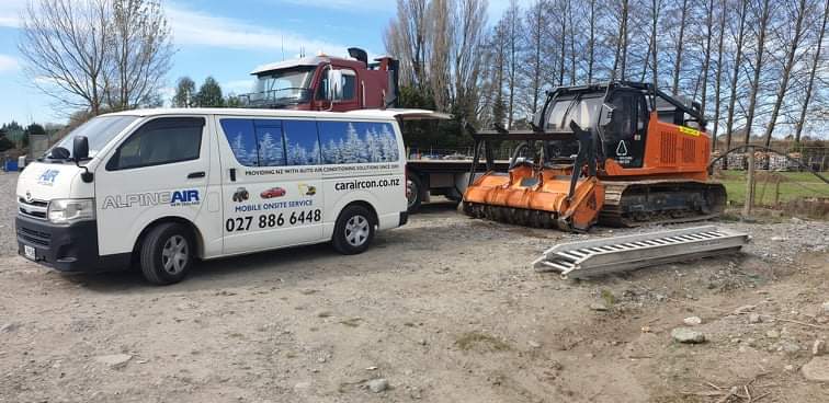 Alpine Air NZ white mobile service van showing phone 027 886 6448, parked on a rural Canterbury work site beside a forestry mulcher and truck