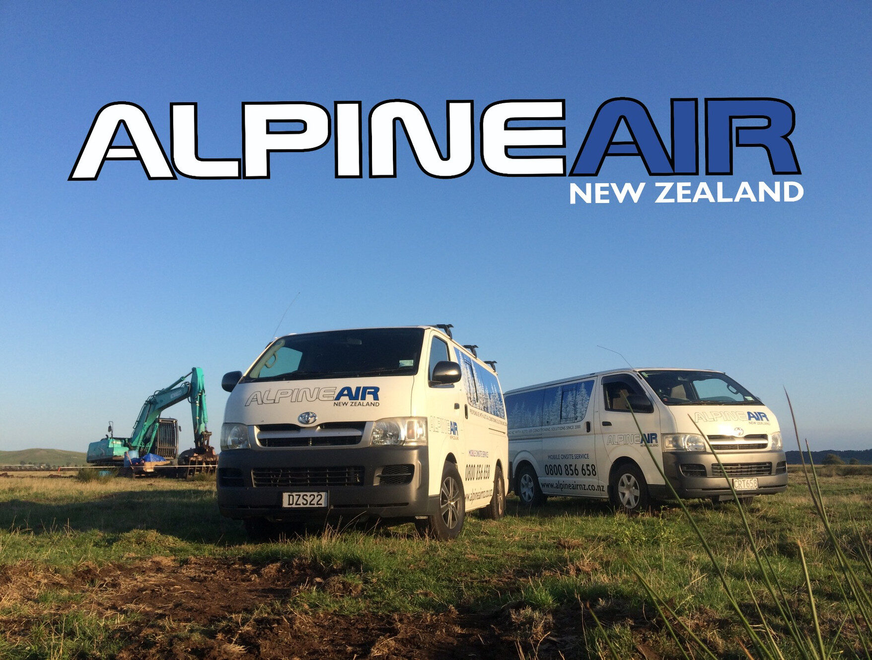 Two Alpine Air New Zealand mobile service vans in a Canterbury field with earthmoving machinery under a clear blue sky